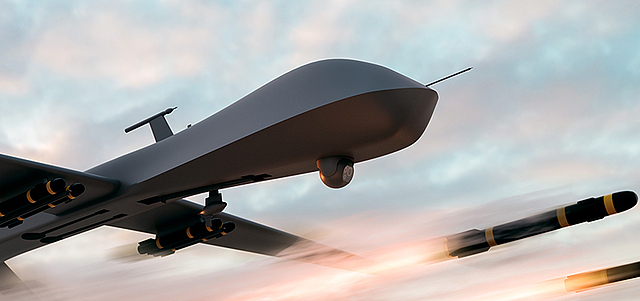 Military drone in flight, shown from below, with visible drive and wing components.