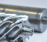 Close-up of a rotor manufactured on an EMAG SU machine. The shiny surface shows the precision milled helical structure and sharp edges. 