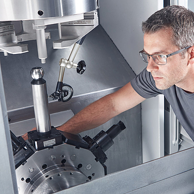 An EMAG technician professionally repairing a turret - part of the best price offer for OEM repairs. 