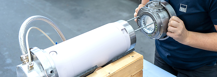 Detailed view of a disassembled EMAG spindle on a workbench with visible precision components and maintenance tools 