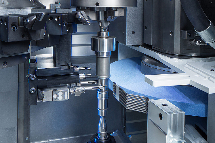 Work area of the EMAG VTC 100 GT during CNC grinding of shafts.