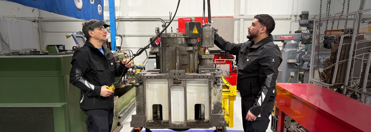 Two EMAG service technicians preparing a worn spindle for disassembly and cleaning at the EMAG U.S. repair facility.